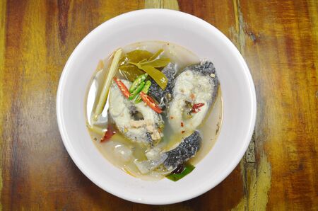 boiled snake head fish in hot and spicy tom yum soup on bowlの写真素材