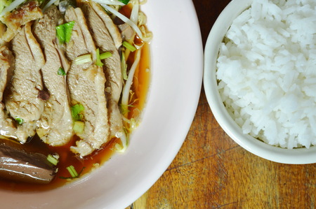 boiled duck meat and blood in brown Chinese herb soup on bowl eat couple with rice