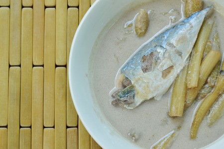 Thai coconut curry of steamed mackerel and lotus stems on bowlの写真素材