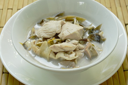 boiled chicken with slice banana blossom in coconut milk soup on bowlの写真素材