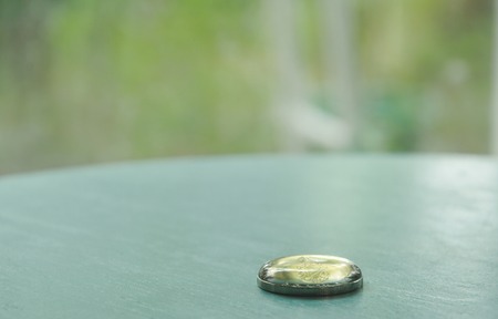drop of water top on Thai baht coin