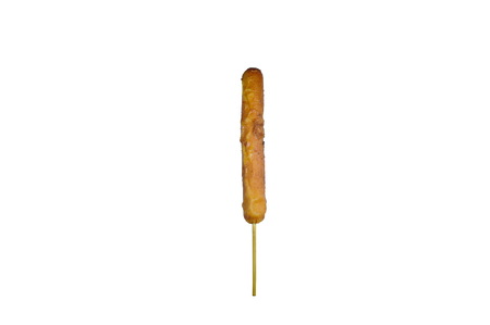 fried pork sausage dressing sweet and spicy chili sauce stabbing in wooden stick on white backgroundの写真素材