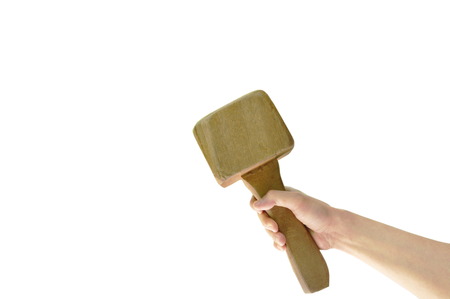 Human hand holding big wooden hammer on white background