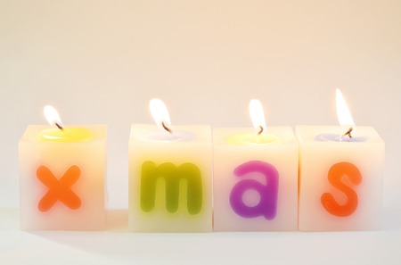 candle fire arranging X Mas word on white backgroundの写真素材