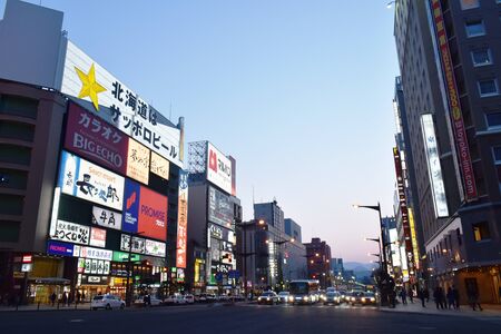Hokkaido Japan March, 5 2019 : building and LED advertising  banner on Tanukikoji walking street in Sapporo at sunsetのeditorial素材