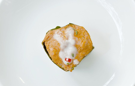 steamed fish with curry paste stuffed slice cabbage in banana leaf tray on plateの写真素材