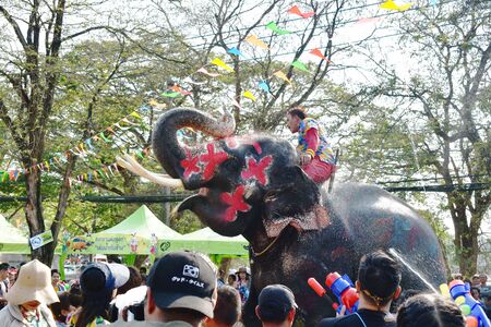 Ayutthaya Thailand April 14, 2019 : elephant splashing water between tourist in Songkran festivalのeditorial素材