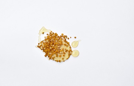 honey and bee pollen in white backgroundの写真素材