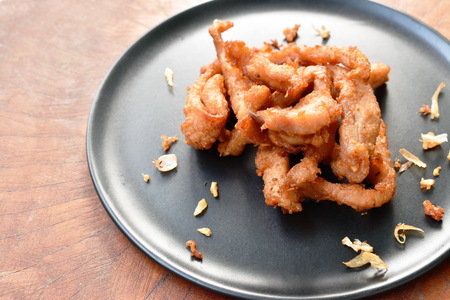 fried slice salty pork with crispy garlic on plateの写真素材