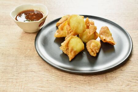 fried crispy Chinese dumpling paste wrapped egg quail dipping sweet and spicy sauceの写真素材