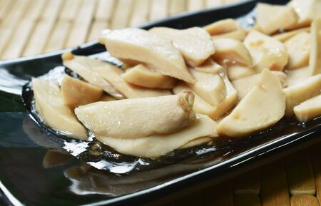 stir fried slice mushroom with pork in oyster sauce on plateの写真素材