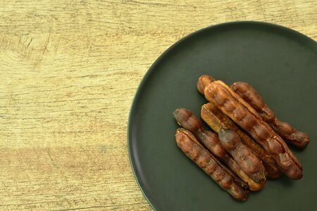 dry pickled tamarind taste sweet and sour Thai preserved food on plate