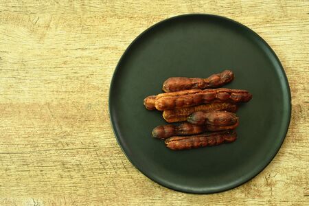 dry pickled tamarind taste sweet and sour Thai preserved food on plateの写真素材