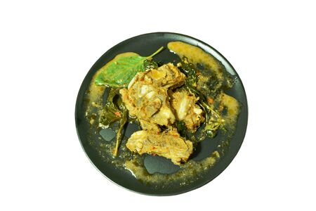 spicy stir fried pork bone with herb and curry on plateの写真素材