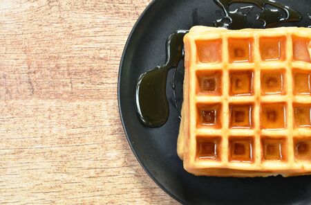 baked butter waffle dressing honey syrup on plateの写真素材