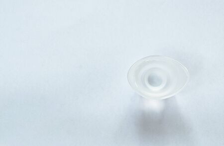 eye wash solution in cup on white background
