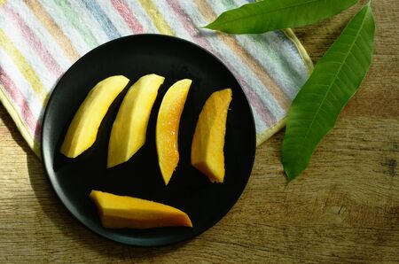 Barracuda mango tropical fruit sweet taste slice on plateの写真素材