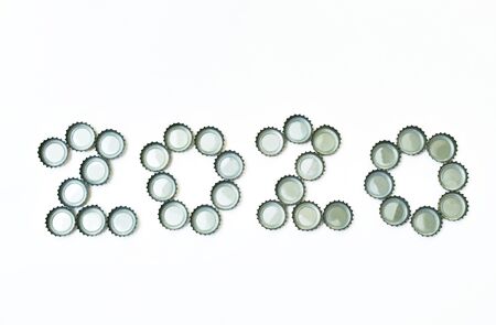 tin bottle cap for cover beer or soda arranging year 2020 on white background