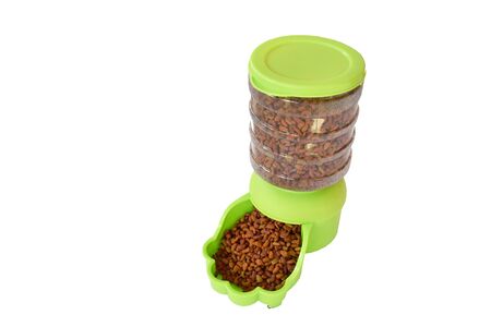 dry pet food in green automatic pet feeder for dog and cat on white backgroundの写真素材