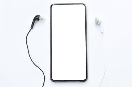mobile phone with earphone on white backgroundの写真素材