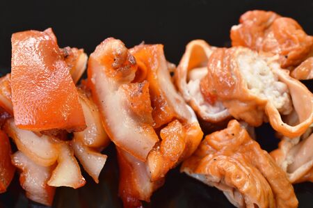 roasted pork neck and innards on plate dipping with tamarind sauceの写真素材
