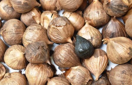 black garlic healthy food arranging on white backgroundの写真素材