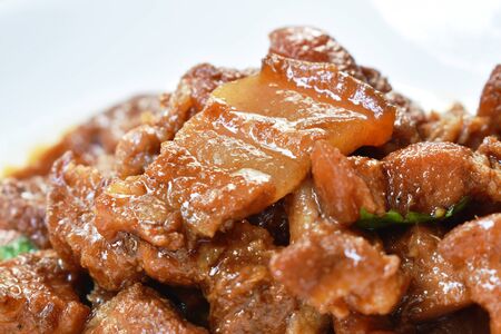 fried slice pork belly in sweet gravy sauce on dishの写真素材