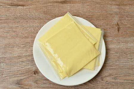 cheese in clear plastic packing arranging on dishの写真素材