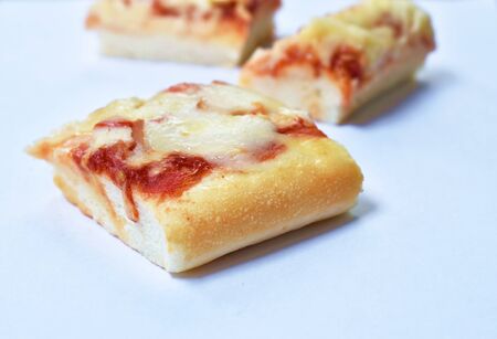 piece of pizza topping sausage and cheese on white backgroundの写真素材
