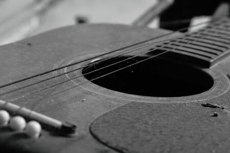 old guitar and broken string in homeの写真素材