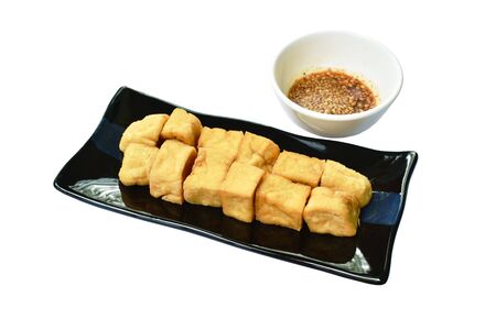 deep fried tofu dipping with sweet crushed bean sauce on plateの写真素材