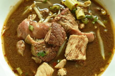 braised pork and ball with bean sprout in brown soup on bowlの写真素材