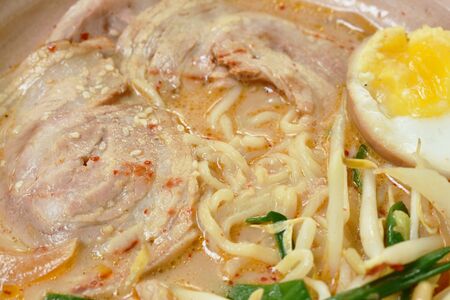 miso ramen or Japanese yellow noodles topping slice braised pork in soybean soup on bowl