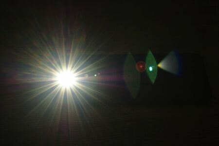 flashlight of mobile phone on table in dark night