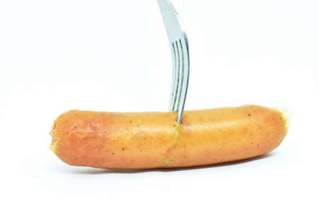 fried pork sausage stabbing by silver fork on white backgroundの写真素材