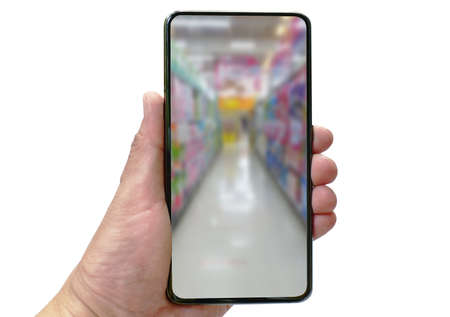 mobile phone holding on human hand with blur supermarket shelf screen concepts on-line shopping in white backgroundの写真素材