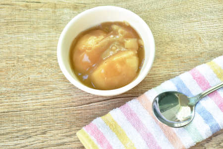 mashed potato dressing gravy sauce and silver spoon on clothの写真素材