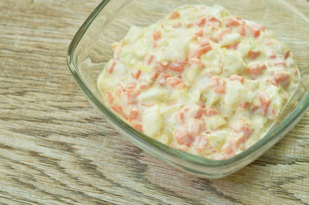 coleslaw chop cabbage with carrot in mayonnaise sauce in glass bowl on tableの写真素材