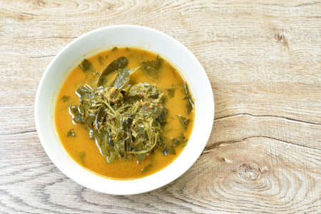 steamed curry salmon fish with squid and mussel wrapped in banana leaf