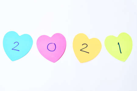 colorful sticky paper note with hearth shape write new year  2021 on white background
