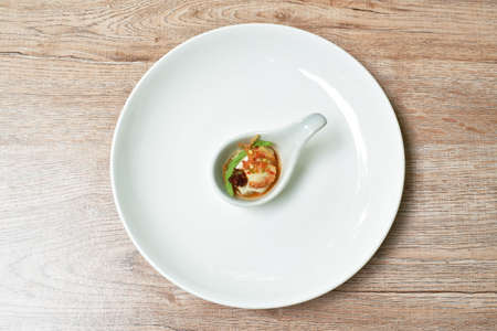 fresh oyster eating couple acacia leaf and fried slice shallot dipping spicy sauce on spoonの写真素材