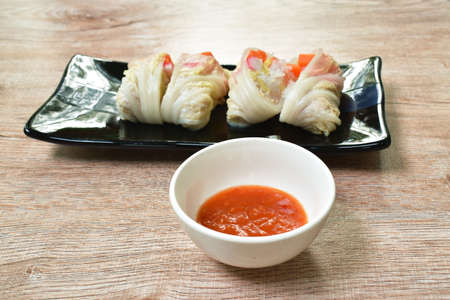 steamed Chinese cabbage stiffed glass noodles and carrot with crab stick on plate dipping sukiyaki...