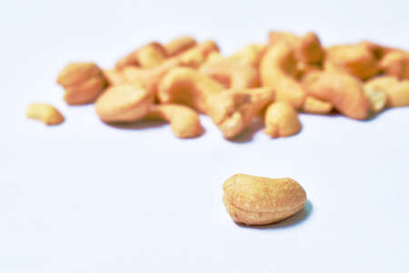 roasted salty cashew nuts arranging on white backgroundの写真素材