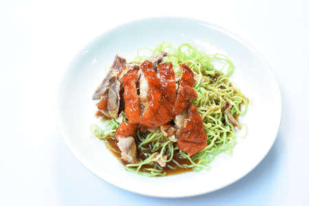 Chinese jade noodles topping slice roasted duck dressing sweet soy sauce on plateの写真素材
