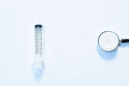 syringe and stethoscope medical equipment for doctor listening pulse of patient on white backgroundの写真素材