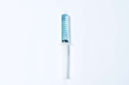 syringe medical equipment with blue liquid vaccine arranging on white background
