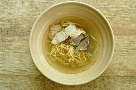 Chinese egg yellow noodles topping slice boiled pork and spleen with soup in bowlの写真素材