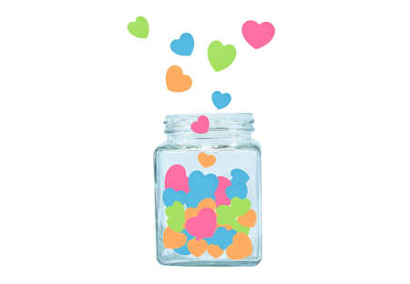 colorful heart paper floating in glass bottle on white backgroundの写真素材