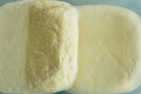 white tofu food ingredient preserved in fresh water on plastic box