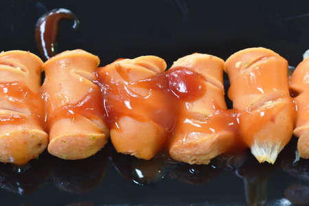 pork sausage dressing ketchup and chili sauce on plate